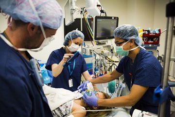 Child life specialist in operating room while anesthesia is being given to patient
